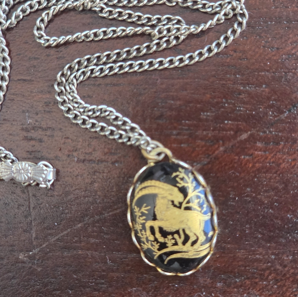 Vintage black and gold oval necklace with a glass cabochon Capricorn pendant